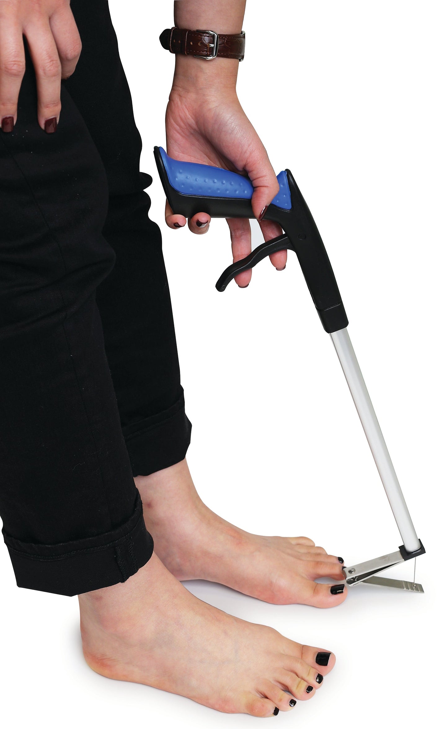 Pistol grip toe nail clipper in use at persons toes